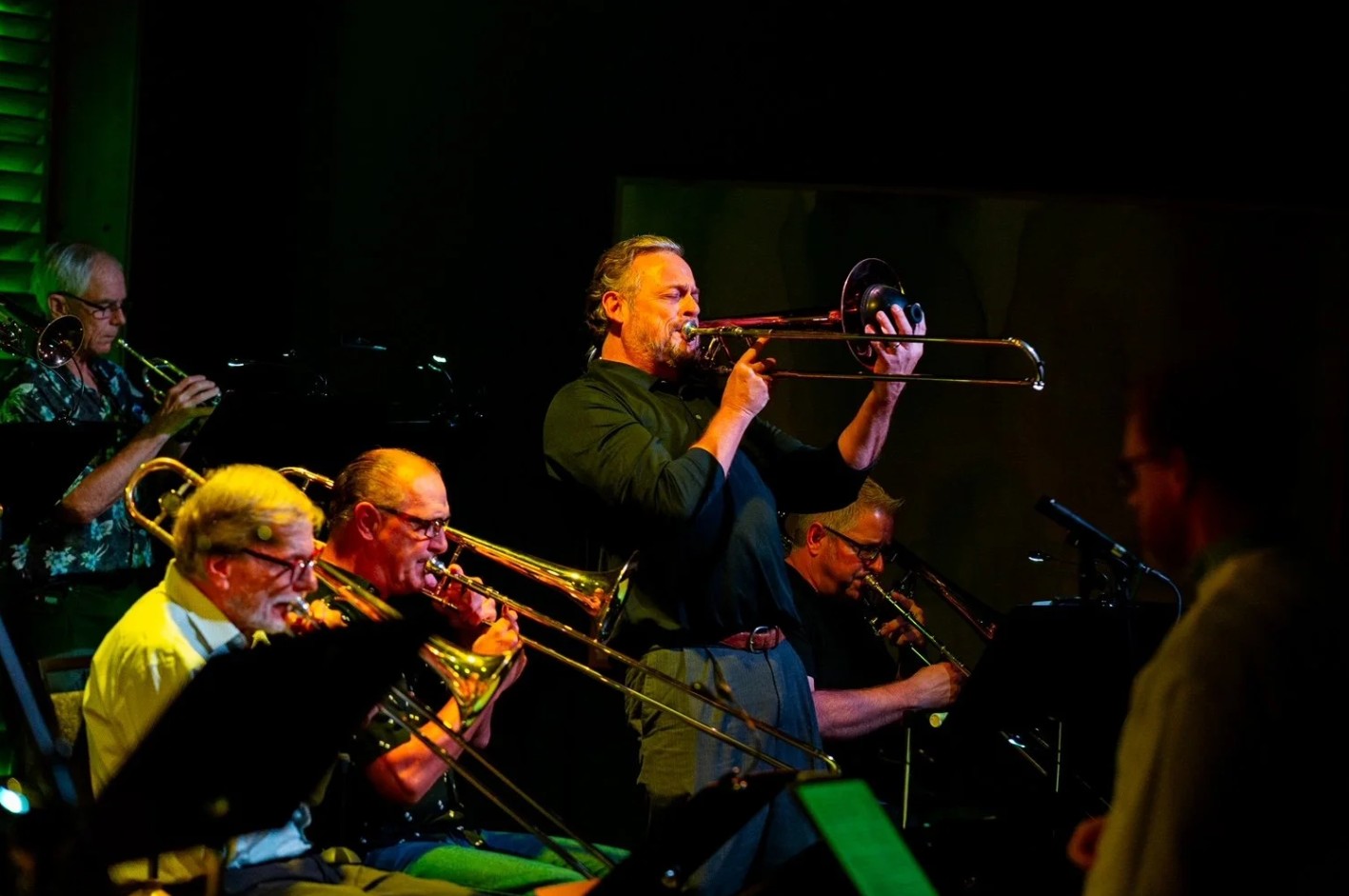 Michael J. Corcoran performing on trombone alongside musicians in the NMC Jazz Ensemble